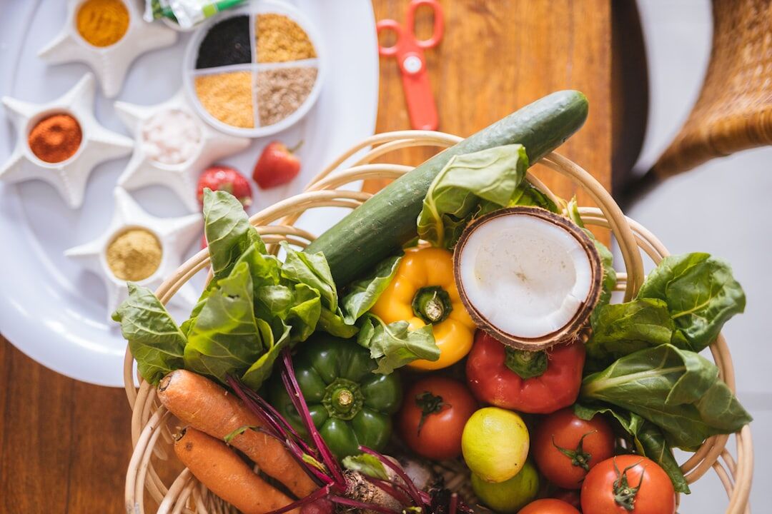 Fresh spring vegetables and herbs on a kitchen table