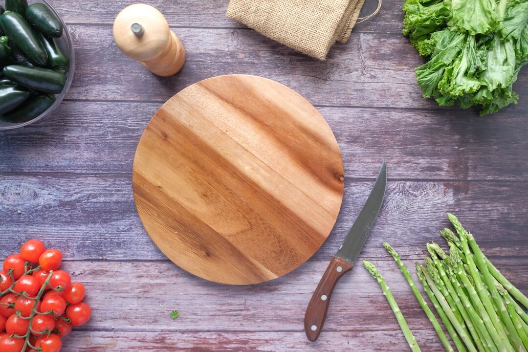 person chopping vegetables on cutting board