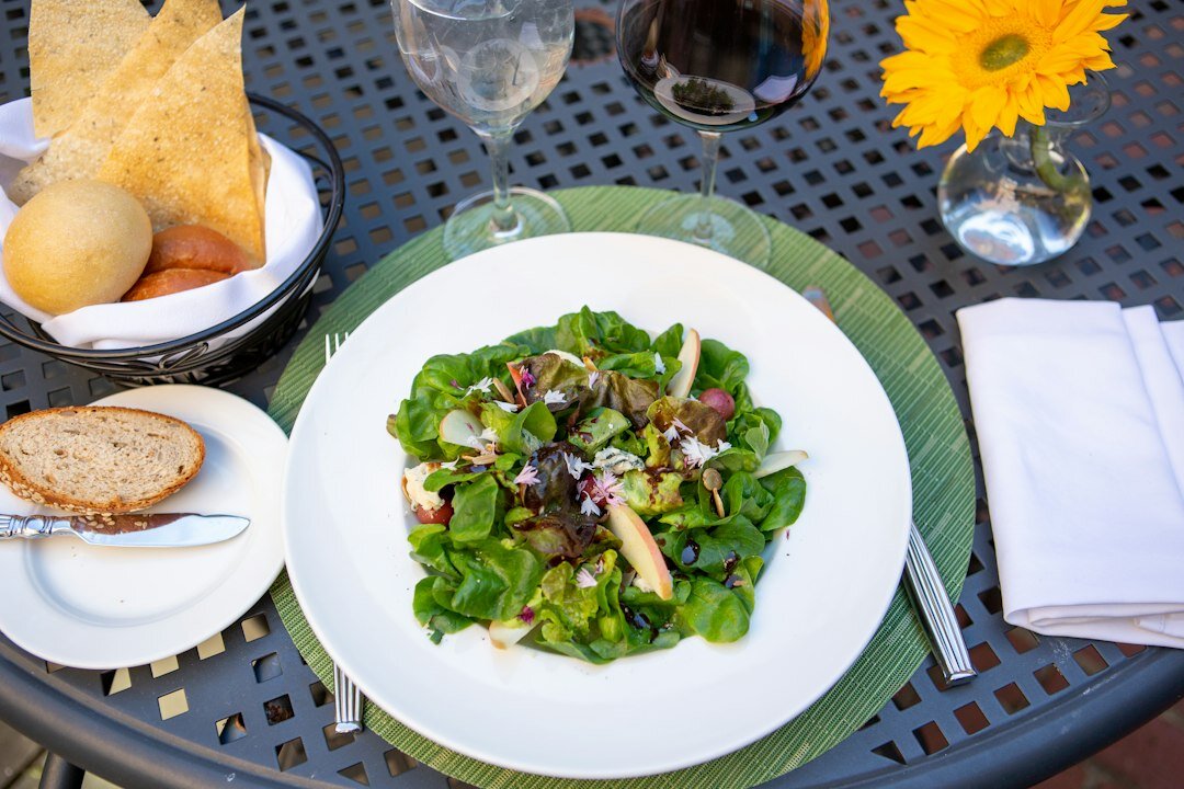 Summer grilled vegetables and fresh salad on a garden table